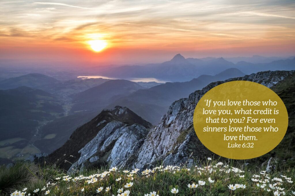 A mountain sunrise with is the backdrop of a quote from Luke 6:32.