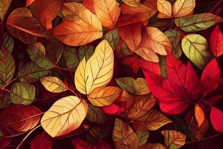 Red, yellow, and green autumn leaves in a pile.