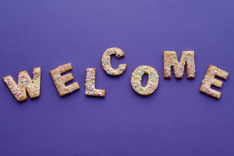 Letters spell "welcome" against a purple background.